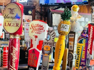 Beer taps featuring Southern Barrel, Service Brewing, and Yuengling at The Warehouse Savannah