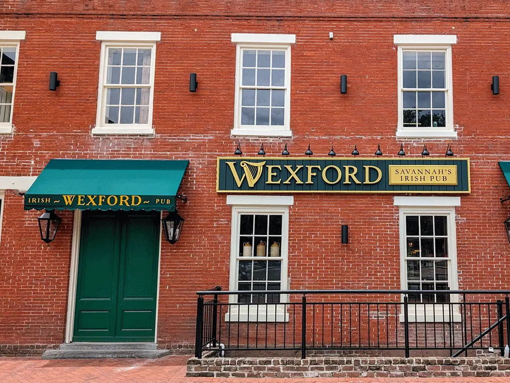 Wexford Irish Pub Savannah exterior with green awnings and signage